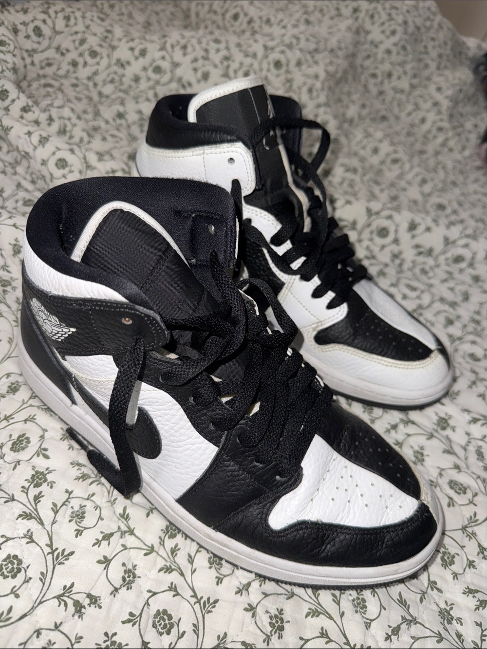 Black and white split color Nike Jordan 1 sneakers